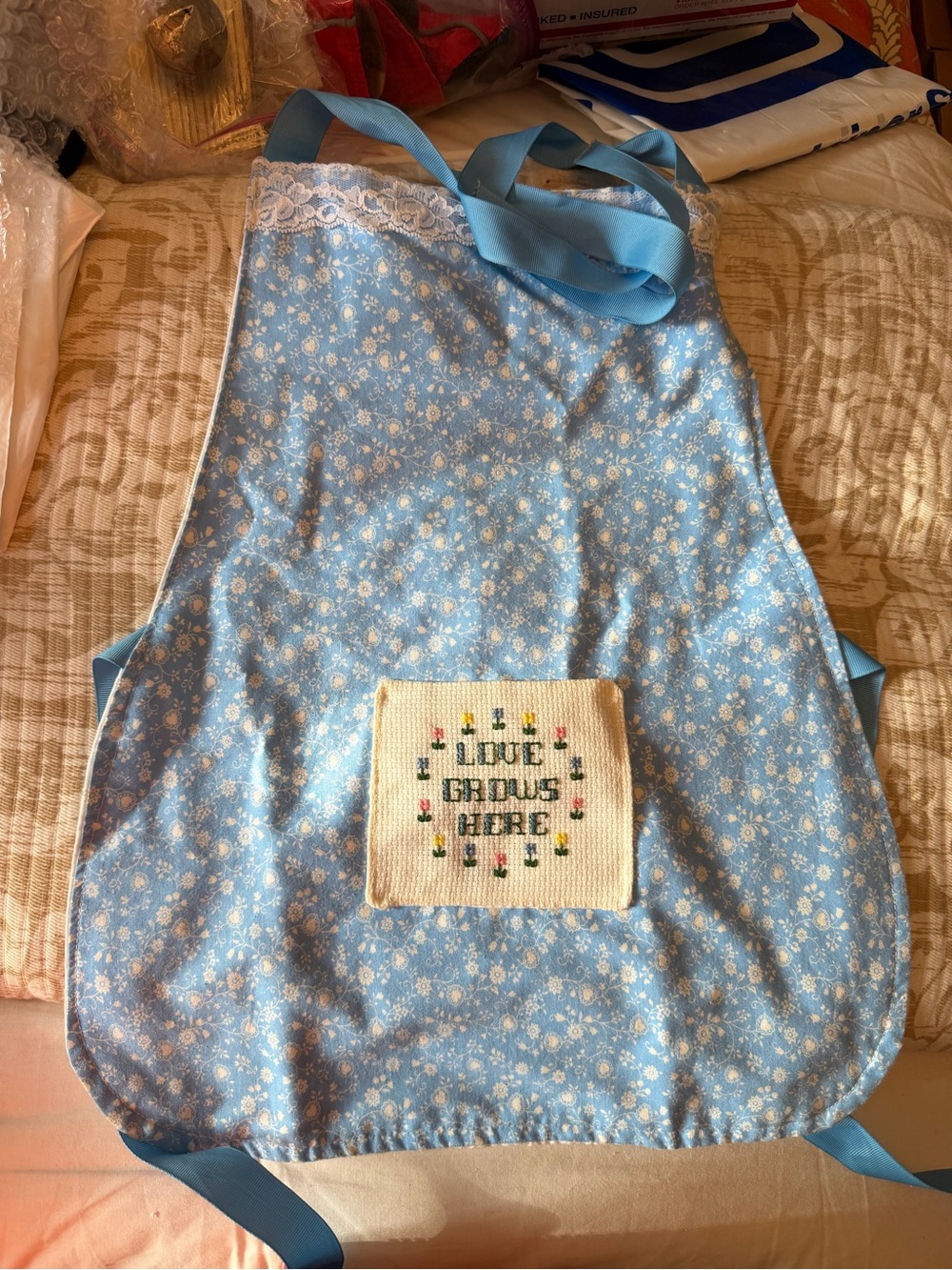 Little Girls Blue Floral Apron with Embroidered 'Love Grows Here' Patch